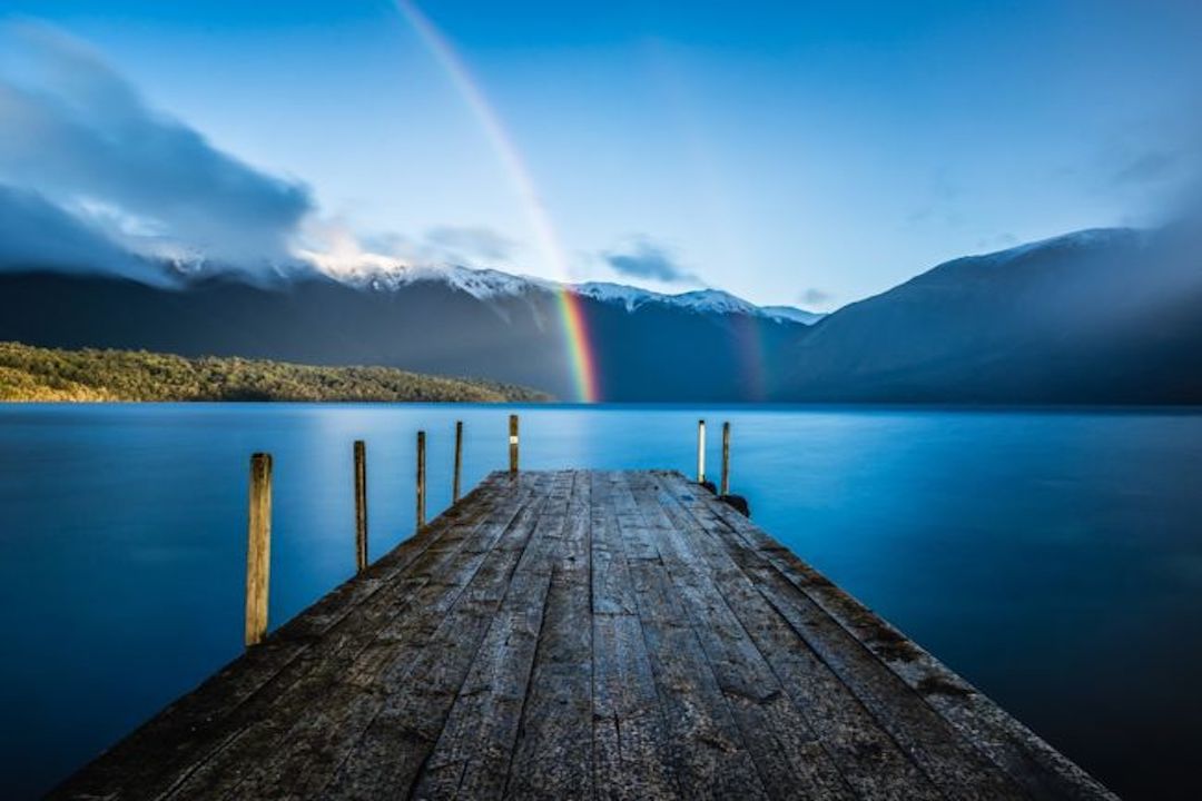 Dock out to lake with rainbow